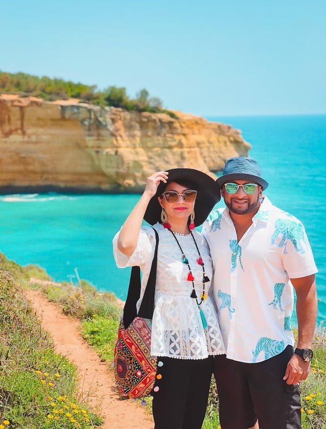 Muslim travel couple on beach cliffs 