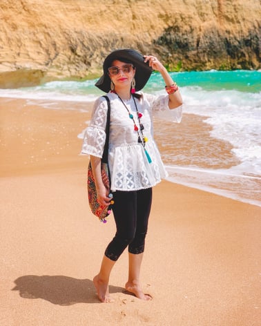 Muslim travel blogger on sandy beach 