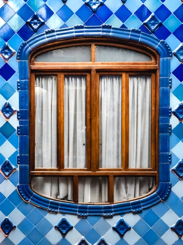 Window surrounded by blue tiles in Casa Batllo atrium