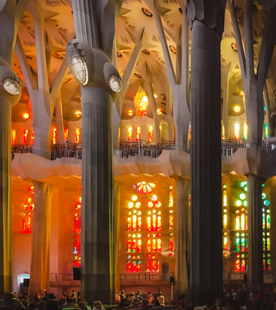 Colorful stained glass and tree pillars inside Sagrada Familia