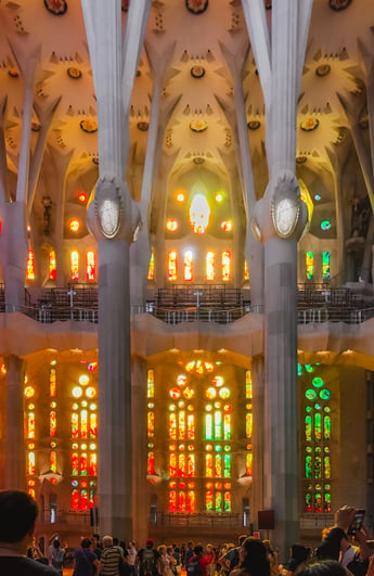 Sun streaming in through stained glass inside Sagrada Familia
