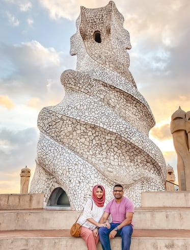 muslim couple beside white warrior sculpture on Casa Mila's rooftop