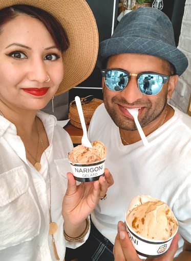 Muslim travelers wearing hats holding gelato in cups in Cadiz