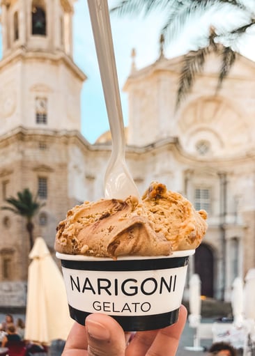 Gelato in a cup with the Cadiz cathedral in the background