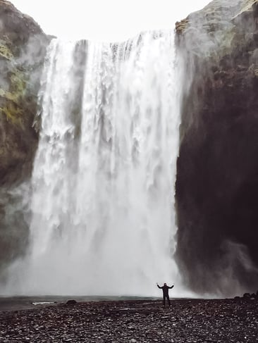 Man close to Skogafoss waterfall