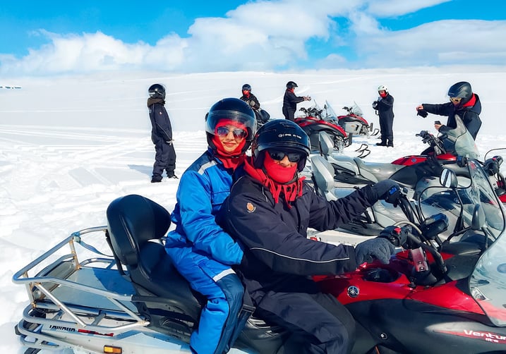 Couple on a snowmobile on a glacier in Iceland