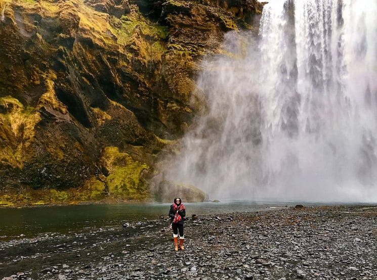 Muslim blogger with rocks and waterfall mist