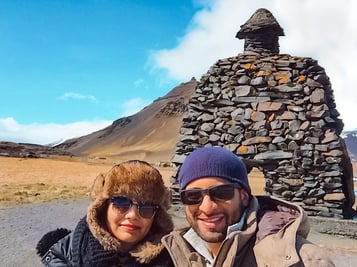 Muslim travel couple in front of rock sculpture