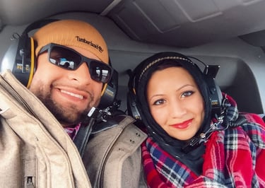 muslim travel couple on helicopter with headsets