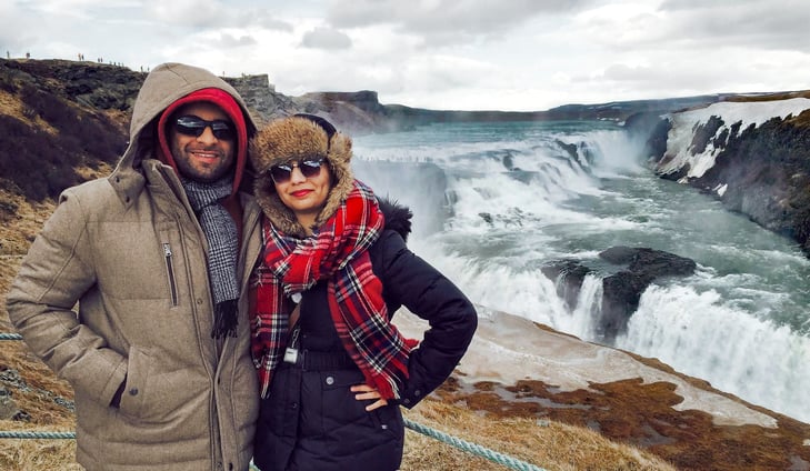 Muslim couple wearing scarves with Gullfoss waterfall