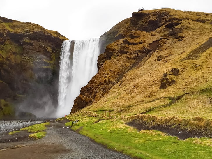 Vik waterfall beside grassy hills