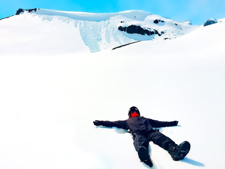 Man lying on snow-covered Langjökull glacier
