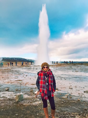 Muslim blogger with Strokkur geyser erupting