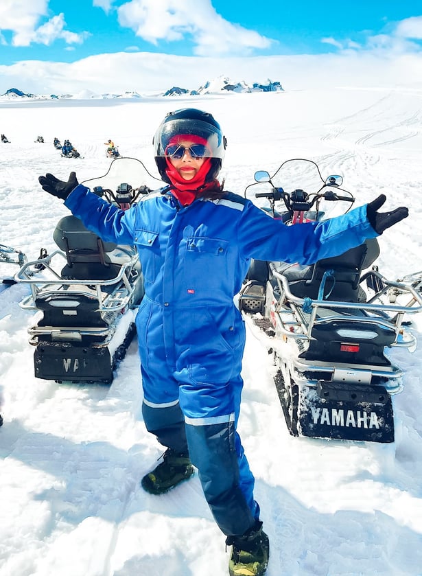 woman in blue snow suit posing on Langjökull glacier