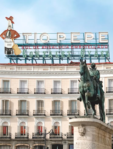 Tio Pepe sign and King statue at Puerta del Sol Madrid