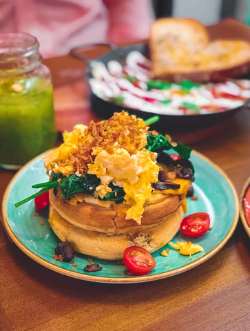 Pancakes topped with eggs at halal brunch restaurant in Madrid