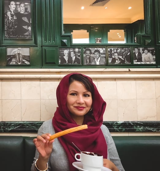 Muslim blogger eating churros with chocolate in Madrid