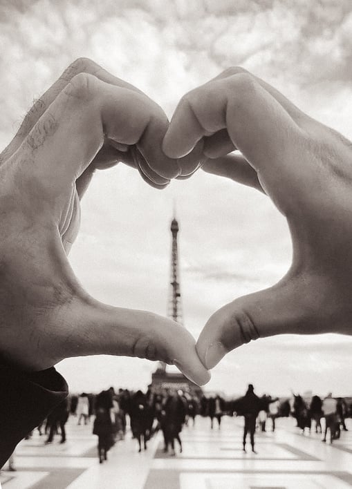 Hands making heart shape with Eiffel Tower