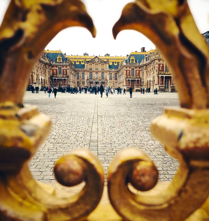 Palace of Versailles through golden gates