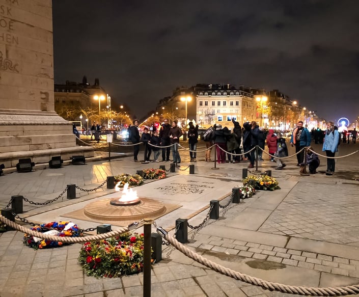 Tomb of the Unknown solider surrounded by flowers at Arc de Triomphe