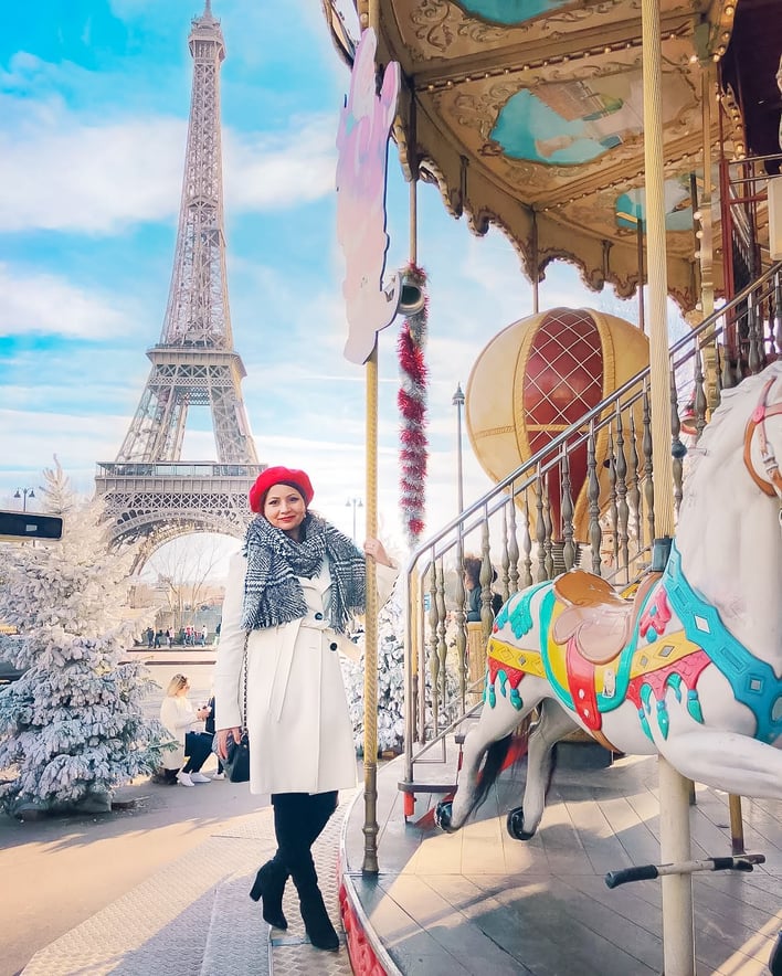 Muslim blogger on carousel with Eiffel Tower