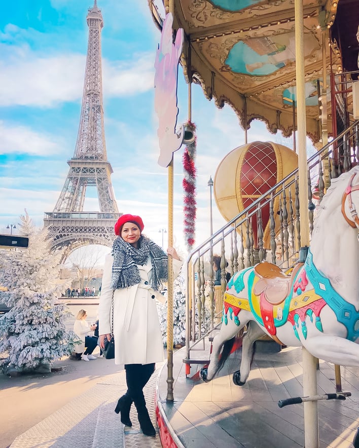 Muslim blogger on carousel with Eiffel Tower