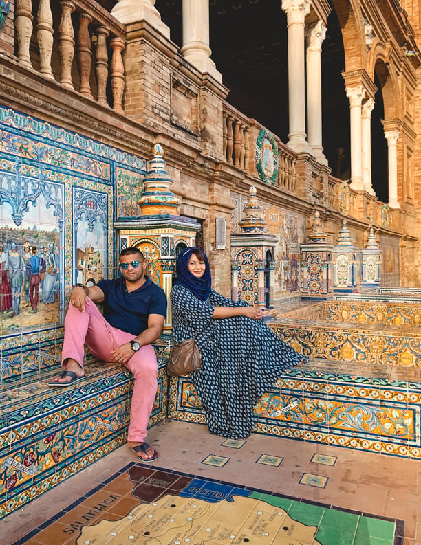 Muslim couple seated on ceramic tiled benches at Plaza de Espana