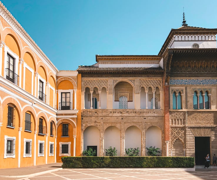 Yellow and brown facade of Palace of Don Pedro at Seville Alcazar