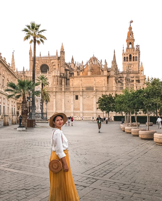 Muslim woman standing in front of Seville Cathedral
