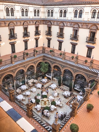 Open courtyard with tables in Seville hotel