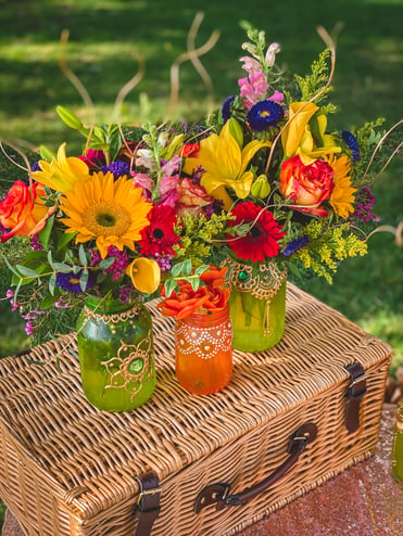 Colorful flowers inside mason jars with henna pattern