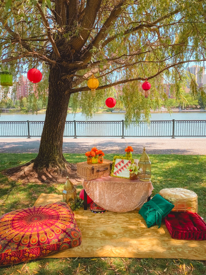 Outdoor Eid party decor with colorful cushions and lanterns